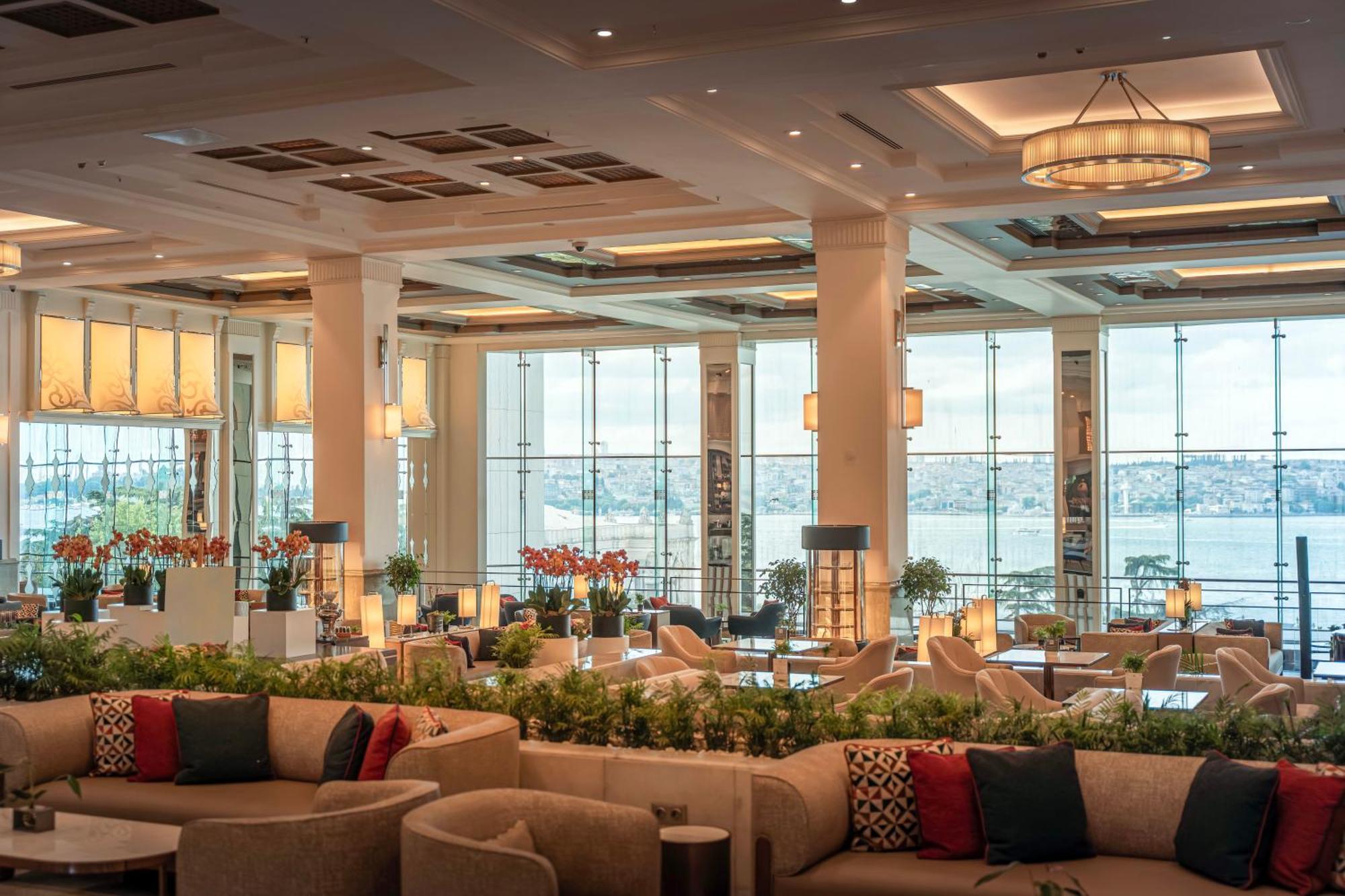 Swissotel The Bosphorus Istanbul Exterior photo The photo depicts a spacious and elegantly designed interior of a restaurant or lounge area. The space is characterized by large windows that provide a view of the outside, possibly overlooking a body of water or a scenic landscape. 

The decor inclu